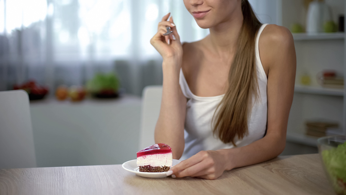 Girl chooses cake instead of salad, temptation to stop dieting, unhealthy food